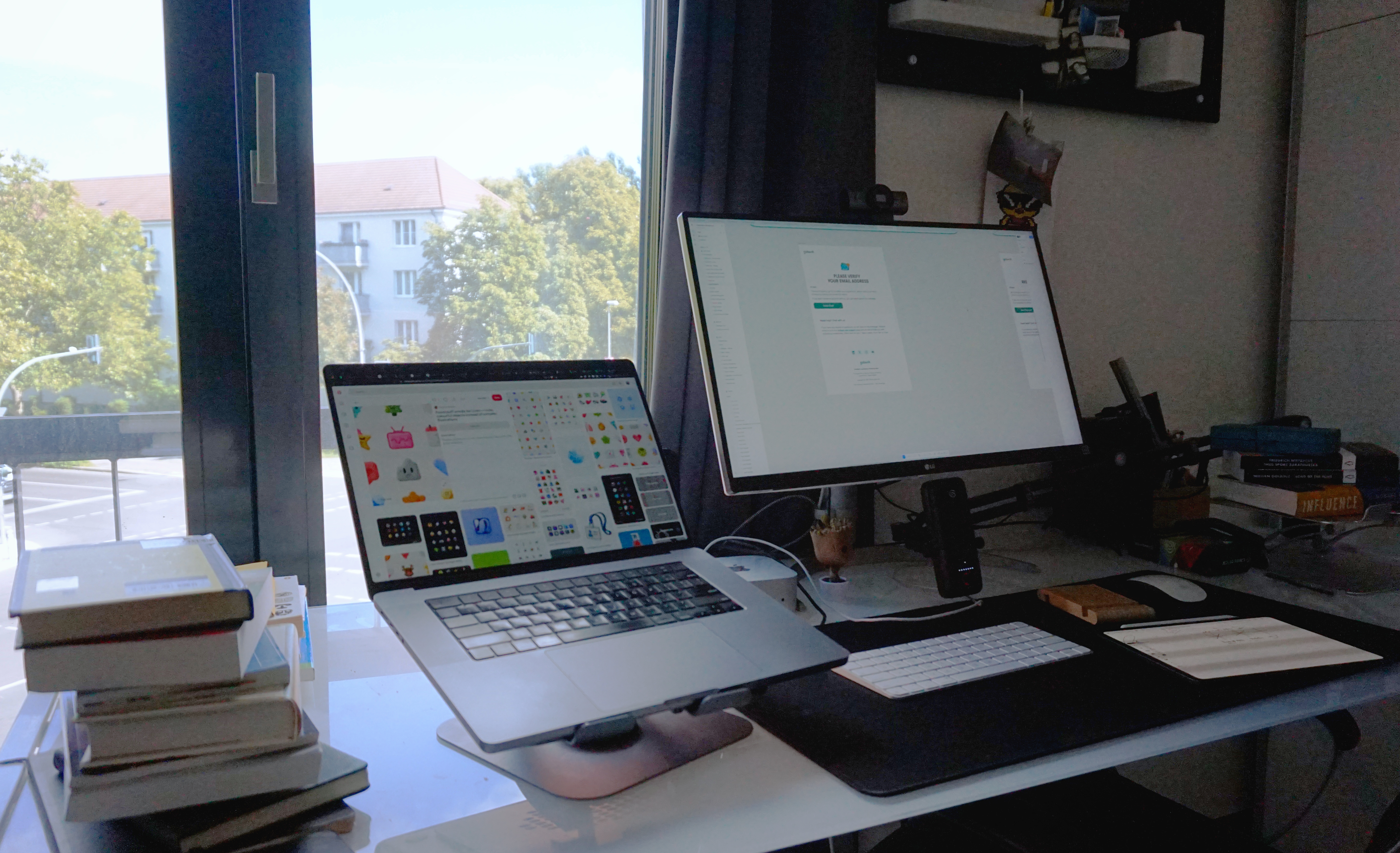 Cadara workspace with a laptop and desktop monitor beside a window